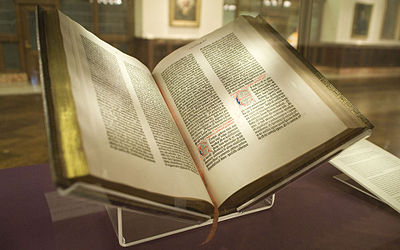Image of the Gutenberg Bible, open in a New York Public Library Display.